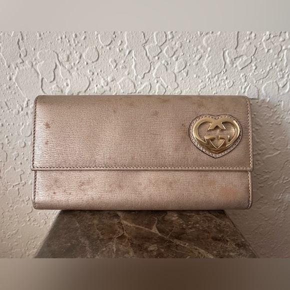 Gucci Handbags - Authentic Gucci Lovely Heart Gold Wallet.